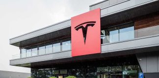 Musk Links Tesla Firing To Austin Murders Tesla office building with large red logo sign