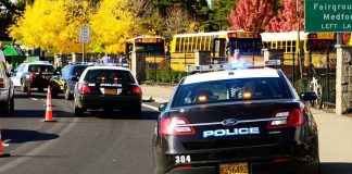 School Hikes Turns DEADLY – Student Picks Up Unexploded Missile Police cars with lights on near school buses on a city street