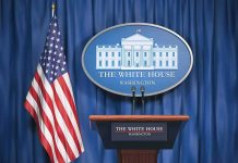 White House press briefing podium and US flag