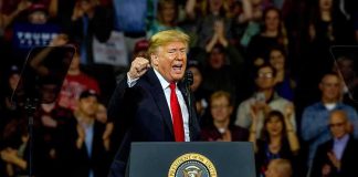 Trump Answer Stuns When Asked If He’ll Accept Midterm Results Donald Trump speaking at a rally behind a presidential podium