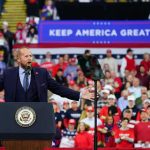 Youtube Star Ignites Trump Rally Frenzy Crowd at a political rally with a speaker at a podium; Stephen Paea, Curtis Lofton, Walter Jones, John Sullivan, and Colin David Jones present