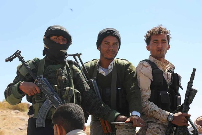 Three armed men standing outdoors