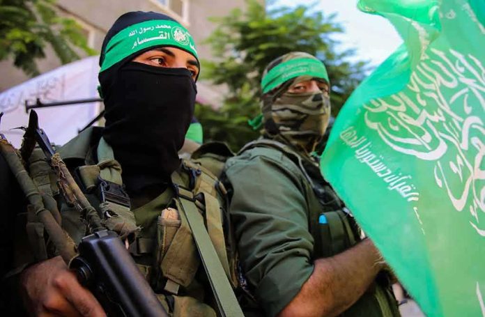 armed men in green headbands holding a green flag