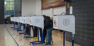 AI Confirms 3 Huge Lies Told By Dem Candidate For Governor Voters at polling booths in a gymnasium