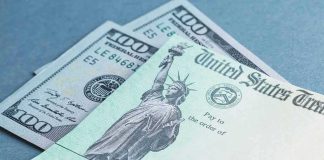 U.S. Treasury check and hundred-dollar bills