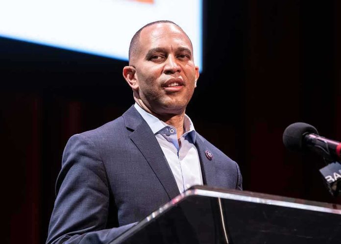 Man in a suit speaking at a podium with a microphone