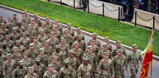Troops Rebel From Firing Squad Duty Soldiers in camouflage uniforms march in formation on a street