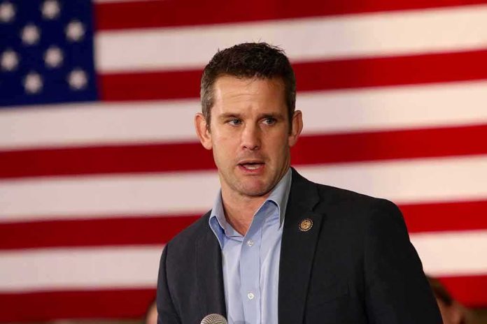 shutterstock_381918718 man speaking in front of a large American flag