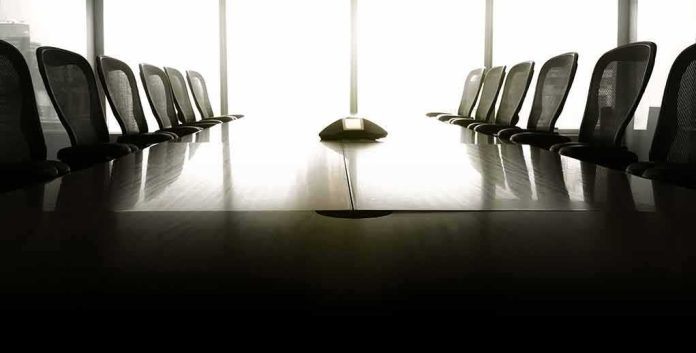 shutterstock_595494629 empty conference room with long table and chairs