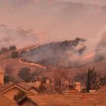 Wind Driven Wildfire WRECKS Malibu Wildfire burns on hillside near suburban homes
