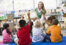 Teacher reading to children in a library circle