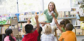 Teacher reading to children in a library circle